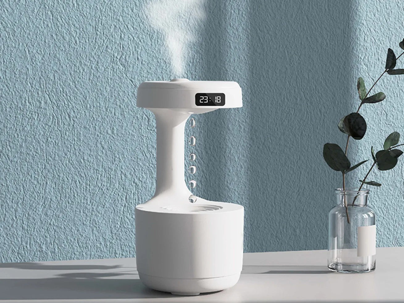 White humidifier on a table with a light blue wall in the background