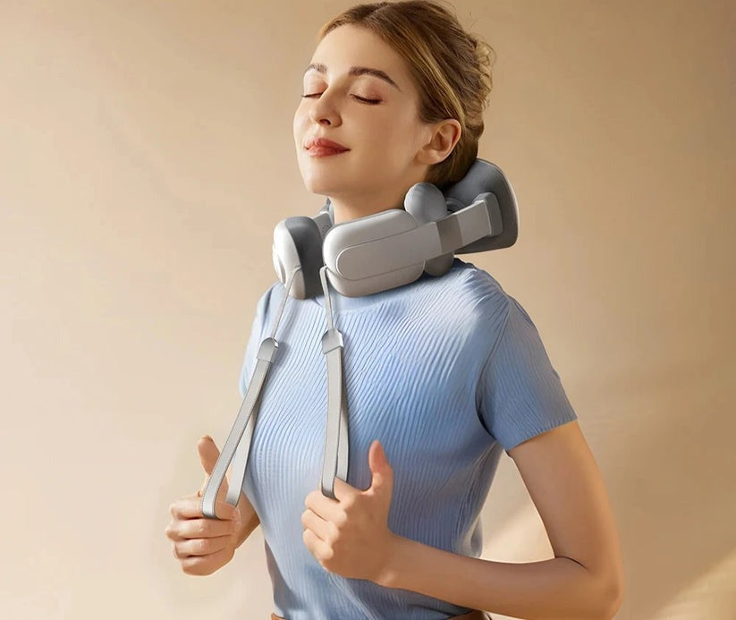 Woman using a neck and shoulder massager against a beige background